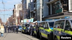 Police talk near the scene after a car drove into a crowd, in Mannheim, Germany, March 3, 2025.