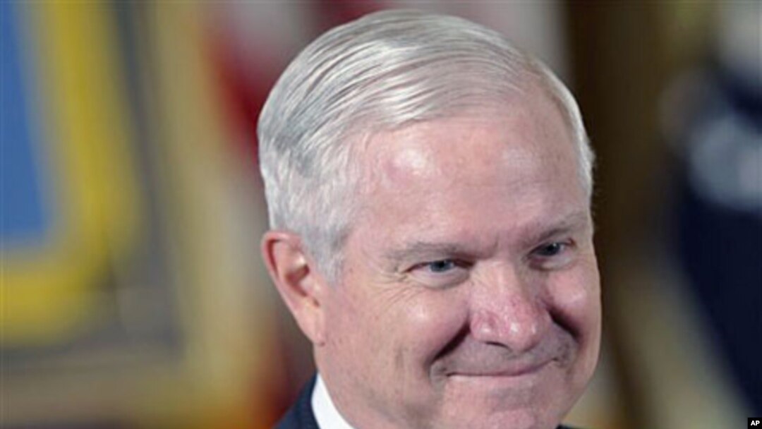 Defense Secretary Robert Gates waits for the start of a ceremony in the East Room of the White House in Washington, May 2, 2011