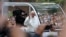 Pope Francis waves to the crowd from his popemobile as it moves through Central Park in New York, Sept. 25, 2015.