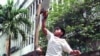 A Filipino street kid imitates a Michael Jordan slam dunk as they play their own kind of basketball at a back street in Manila. Despite an average height of 5 feet and 4 inches among Filipinos, basketball is so popular a sport here that there's almost no 