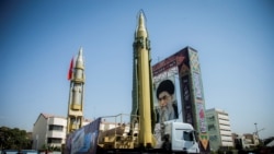 FILE - A display featuring missiles and a portrait of Iran's Supreme Leader Ayatollah Ali Khamenei is seen at Baharestan Square in Tehran, Iran, Sept. 27, 2017.