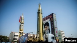 FILE - A display featuring missiles and a portrait of Iran's Supreme Leader Ayatollah Ali Khamenei is seen at Baharestan Square in Tehran, Iran, Sept. 27, 2017.