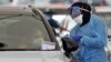  A health worker conducts a COVID-19 test at the St. Vincent's Bondi Beach COVID-19 drive through testing clinic on Dec. 22, 2021, in Sydney. 