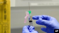 FILE - A clinical research nurse prepares the COVID-19 vaccine to administer to a volunteer, at a clinic in London, Aug. 5, 2020. (AP)