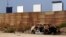 FILE - Prototypes for U.S. President Donald Trump's border wall with Mexico are seen behind the current border fence in this picture taken from the Mexican side of the border in Tijuana, Oct. 12, 2017. 