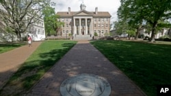 FILE - A sidewalk leads to the South Building on campus at The University of North Carolina in Chapel Hill, N.C., April 20, 2015. 