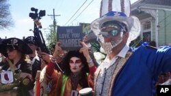 Costumed revelers gather for the annual Krewe of Red Beans march in New Orleans, March 4, 2019. 