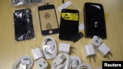 FILE - Counterfeit iPhone accessories are seen in this handout photograph taken Oct. 23, 2011. A Chinese national in the U.S. on a student visa was sentenced Tuesday for smuggling counterfeit Apple products from China into the U.S.