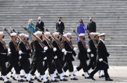 U.S. first lady Jill Biden, U.S. President Joe Biden, U.S. Vice President Kamala Harris and U.S. second gentleman Doug Emhoff watch as troops march in front of the U.S. Capitol, Jan. 20, 2021.