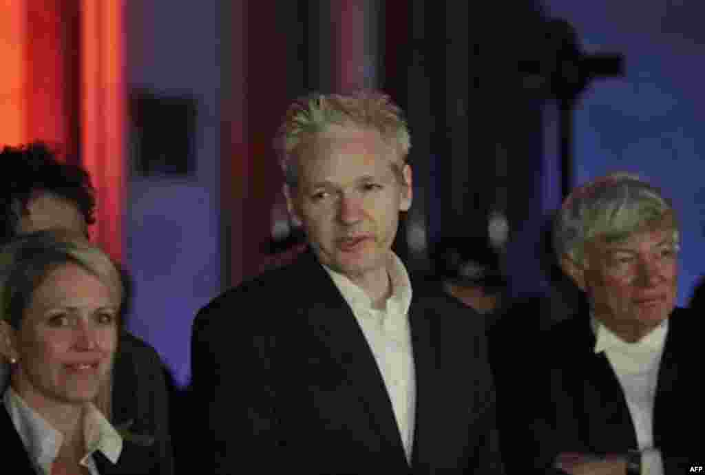 WikiLeaks founder Julian Assange, centre, delivers a statement to the media outside the High Court, London, after his release on bail, Thursday, Dec. 16, 2010. Assange is swapping a Victorian prison cell for an English country mansion after a judge grant