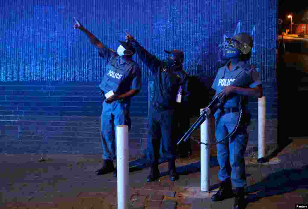 Police officers gesture during a patrol on New Year&#39;s day as a nighttime curfew is reimposed amid a nationwide coronavirus lockdown, in Johannesburg, South Africa.