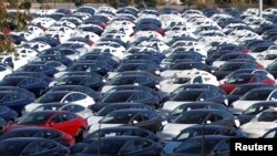 FILE - A parking lot of predominantly new Tesla Model 3 electric vehicles is seen in Richmond, California, June 22, 2018.