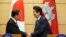 Japanese Prime Minister Shinzo Abe, right, and Cambodia's Prime Minister Hun Sen shake hands after their meeting at Abe's office in Tokyo Monday, Oct. 8, 2018. (AP Photo/Eugene Hoshiko, Pool)