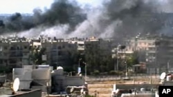This video image taken from amateur video and broadcast by Bambuser/Homslive shows a series of devastating explosions rocking the central Syrian city of Homs, Syria, Monday, June 11, 2012. 