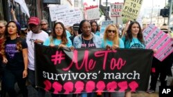 FILE - Participants march against sexual harassment and assault at the #MeToo March in the Hollywood section of Los Angeles, California, Nov. 12, 2017.