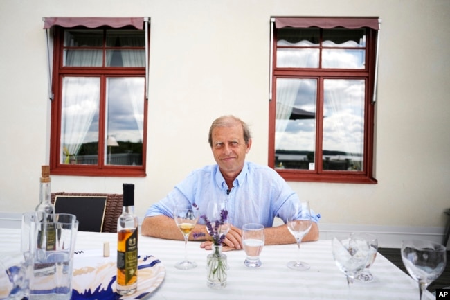 Göran Amnegård, owner of Blaxsta wine, smiles during wine testing in Flen, Sweden, Sunday, July 23, 2023. Amnegård planted his first vines over 20 years ago to launch a commercial vineyard. (AP Photo/Pavel Golovkin)