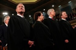 FILE - Supreme Court Chief Justice John Roberts, Associate Justice Elena Kagan, Associate Justice Neil Gorsuch and Associate Justice Brett Kavanaugh before President Donald Trump delivers his State of the Union address Feb. 4, 2020, in Washington.