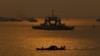 Cambodian fishermen on a motorized boat go fishing in the Mekong River in Phnom Penh, Cambodia, Feb. 2, 2021. 