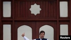 Pakistan's Prime Minister Imran Khan gestures as he speaks during a countrywide 'Kashmir Hour' demonstration to express solidarity with the people of Kashmir, at the Prime Minister's House in Islamabad, Pakistan, Aug. 30, 2019. 