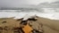 FILE - The wreckage from a capsized boat washes ashore at a beach near Cutro, southern Italy, Sunday, Feb. 26, 2023. 