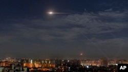 File - In this photo released by the Syrian official news agency SANA, shows missiles flying in the sky in Damascus, Syria, Jan. 21, 2019. Syria’s defense ministry says two soldiers were injured in an Israeli air attack on military posts Monday.