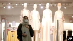 A woman wearing a protective face mask to help prevent spread of the coronavirus walks through a shopping center, in Tehran, Iran, Wednesday, Aug. 19, 2020. Iran surpassed 20,000 confirmed deaths from the coronavirus on Wednesday, the health…