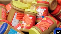 FILE - Returned jars of Peter Pan Peanut Butter are piled up at a supermarket in Atlanta, Georgia, Feb. 16, 2007.