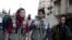 Members of OCHA (Office for the Coordination of Humanitarian Affairs), part of the United Nations, walk in the rebel held besieged town of Kafr Batna, on the outskirts of Damascus, during a distribution of humanitarian aid, Feb. 23, 2016. 