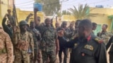 FILE: Sudan's General Abdel Fattah al-Burhan (center, fist raised) talks to troops on May 30, 2023. (Sudanese Armed Forces handout via Reuters.) 