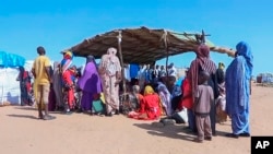 FILE - Sudanese refugees gather outside a field hospital in Acre, Chad, Aug. 15, 2023. 