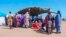 FILE - Sudanese refugees gather outside a field hospital in Acre, Chad, Aug. 15, 2023. 