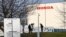 FILE - Members of media stand outside the Honda car plant in Swindon, Britain, Feb. 18, 2019.