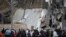 A crowd gathers around the partially collapsed Artz Pedregal shopping mall on the south side of Mexico City, July 12, 2018. 