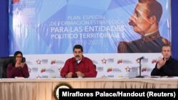 FILE - Venezuela's President Nicolas Maduro (C) speaks during a meeting with pro-government governors and mayors, next to Venezuela's National Constitutional Assembly Delcy Rodriguez (L) and Venezuela's Vice President Tareck El Aissami, at Miraflores Palace in Caracas, Dec. 19, 2017.
