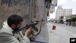 A tribesman loyal to tribal leader Sadeq al-Ahmar secures a street near al-Ahmar's house in Sana'a June 7, 2011