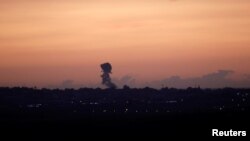Smoke rises at the Gaza Strip following an Israeli strike, as seen from the Israeli side of the border, Nov. 30, 2017. 