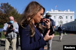 White House Director of Strategic Communications Alyssa Farah puts on her mask after speaking to reporters about U.S. President Donald Trump's coronavirus disease (COVID-19), outside the White House in Washington, Oct. 8, 2020.