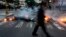 A man walks past a barricade set by anti-government protesters at Altamira square in Caracas, Venezuela, March 6, 2014.