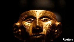 A pre-Columbian gold mask. This artifact is secure in a Colombian museum, but similar objects are sometimes smuggled out of their countries of origin and sold to collectors.