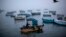 FILE - Fishermen navigate their boat out of the Chorrillo dock in the Pacific Ocean waters of Lima, Peru. Thousands of Chilean fishermen blocked roads with barricades in the region of Los Lagos on Monday and Tuesday.