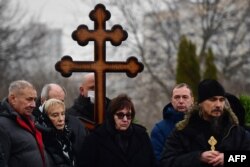 FILE — Lyudmila Navalnaya (C) and Anatoly Navalny (L), parents of late Russian opposition leader Alexei Navalny, attend the funeral ceremony for their son at the Borisovo cemetery in Moscow's district of Maryino on March 1, 2024.