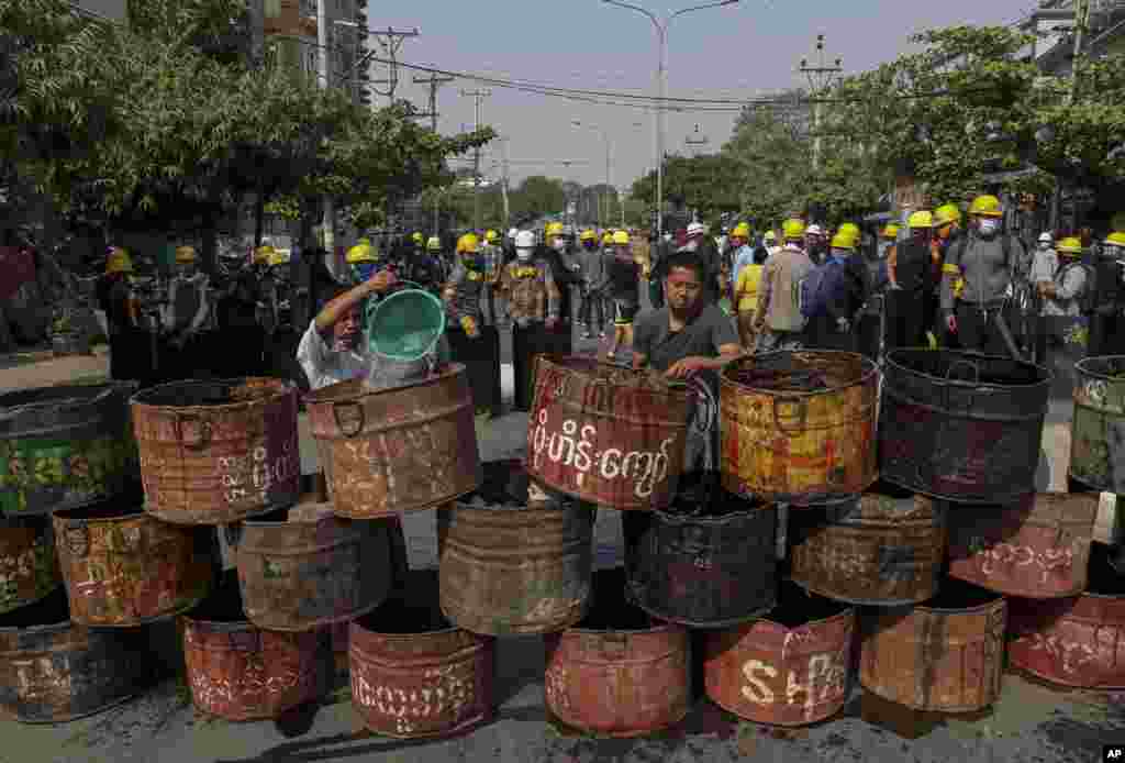 People build barriers to block police in Mandalay, Myanmar.&nbsp;Demonstrators protesting last month&#39;s military coup returned to the streets, following the killing of at least 38 people the day before by security forces.