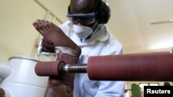 FILE - A worker prepares a prosthesis inside the manufacturing workshop of the Physical Rehabilitation Reference Centre in Juba, South Sudan, July 7, 2011.