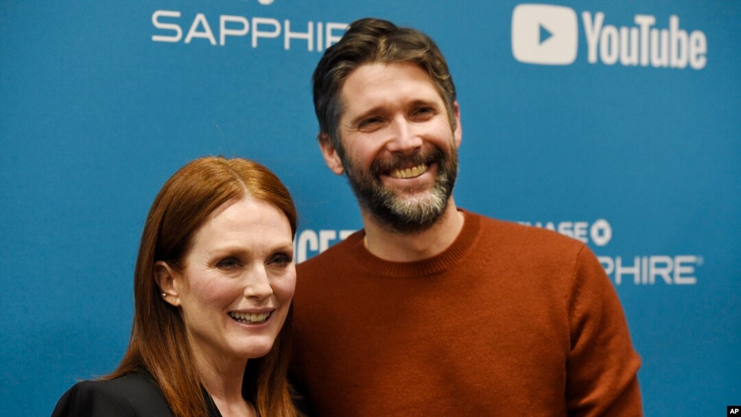 Julianne Moore, left, a cast member in "After the Wedding," poses with her husband, the film's writer/director Bart Freundlich, at the premiere of the film on the opening night of the 2019 Sundance Film Festival, Thursday, Jan. 24, 2019, in Park City, Utah.