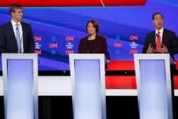 Presidential candidate former Rep. Beto O'Rourke, left, Sen. Amy Klobuchar, former Housing Secretary Julian Castro participate in a Democratic presidential primary debate hosted by CNN/New York Times, in Westerville, Ohio, Oct. 15, 2019.