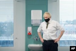 Britain's Prime Minister Boris Johnson visits Chase Farm Hospital in north London, Jan. 4, 2021, part of the Royal Free London NHS Foundation Trust.