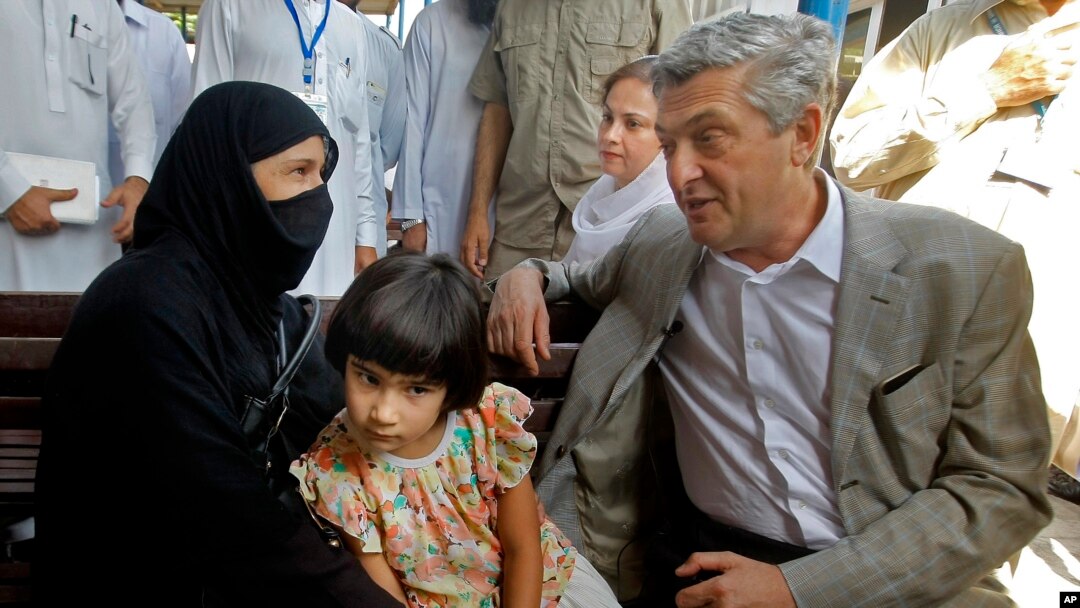 U.N. High Commissioner for Refugees Filippo Grandi talks to an Afghan refugee woman during his visit to the UNHCR's Repatriation Center in Peshawar, Pakistan, June 23, 2016.