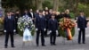 Police officers and members of an honor guard await the arrival of politicians next to wreaths at a memorial for two people, including a child, killed in a knife attack earlier in the week in Aschaffenburg, Germany, Jan. 26, 2025.