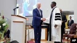 FILE - Reverend Dr. Jamey O. Graham, Sr. right, greets President Joe Biden before Biden speaks at St. John Baptist Church, in Columbia, S.C., on January 28, 2024. 