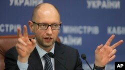 FILE - Ukrainian Prime Minister Arseniy Yatseniuk speaks to the media during a press conference in Kyiv, Ukraine, Nov. 20, 2014. 